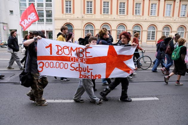 Demonstranten laufen mit Banner 1 Bombe oder 300.000 Schulbücher in der Friedrich-Ebert-Straße während einer Demonstration gegen die Wehrpflicht, Potsdam, 25. September 2026. Schulstreik gegen Wehrpflicht in Potsdam