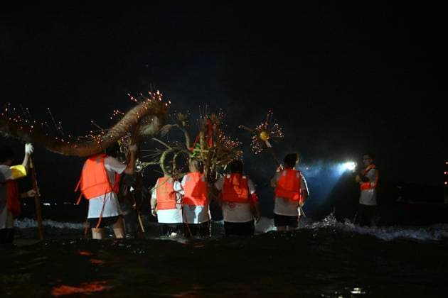 RECORD DATE NOT STATED Hong Kong Pok Fu Lam Village Fire Dragon 2026 Performers putting a Fire Dragon into the sea during a fire dragon dance performance in Wah Fu Estate at Mid-autumn Festival on September 25, 2026 in Hong Kong. (Photo by Kobe Li Nexpher Images) Hong Kong