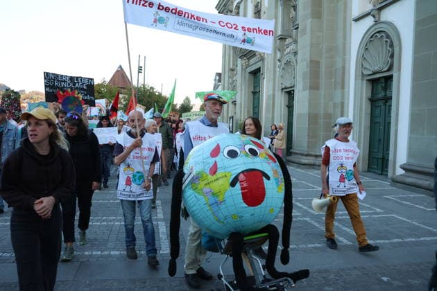 25.09.2026 Stadt Luzern. Demonstration, Klimademo in Luzern gegen Klimawandel,unter dem Motto Kein 50-Grad-Sommer. Bild. Demonstranten mit Weltkugel.