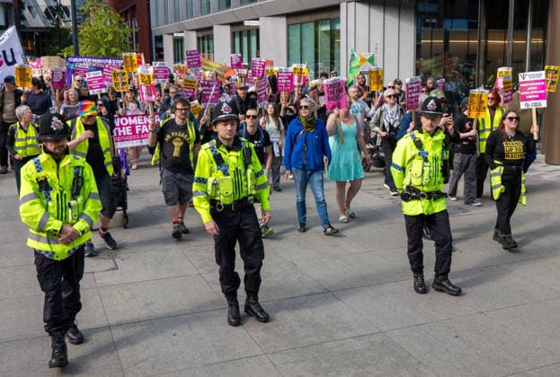 September 26, 2026, Manchester, United Kingdom: Police officers lead marchers past Number10 North during the rally. Activists in Manchester march for Stand Up To Racism against the far right. In addition to anti-racist slogans promoting diversity and migrant rights, demonstrators carried banners of the RNLI (Royal National Lifeboat Institution) following recent Patriot Platform protests. The broad coalition of trade unions, community groups, and political organisations featured prominent banners from BECTU (Broadcasting, Entertainment, Communications and Theatre Union) and Jewish Voice for Labour (JVL). Manchester, United Kingdom. Manchester United Kingdom  - ZUMAs197 20260926_aaa_s197_219 Copyright: xGaryxRobertsx