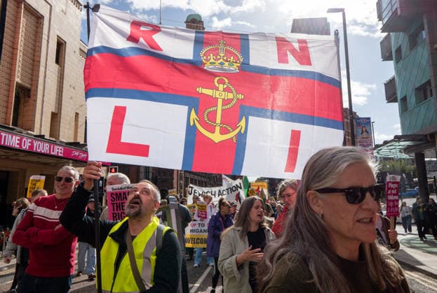 September 26, 2026, Manchester, United Kingdom: Protesters hold a banner with RNLI (Royal National Lifeboat Institution) during the rally. Activists in Manchester march for Stand Up To Racism against the far right. In addition to anti-racist slogans promoting diversity and migrant rights, demonstrators carried banners of the RNLI (Royal National Lifeboat Institution) following recent Patriot Platform protests. The broad coalition of trade unions, community groups, and political organisations featured prominent banners from BECTU (Broadcasting, Entertainment, Communications and Theatre Union) and Jewish Voice for Labour (JVL). Manchester, United Kingdom. Manchester United Kingdom - ZUMAs197 20260926_aaa_s197_210 Copyright: xGaryxRobertsx
