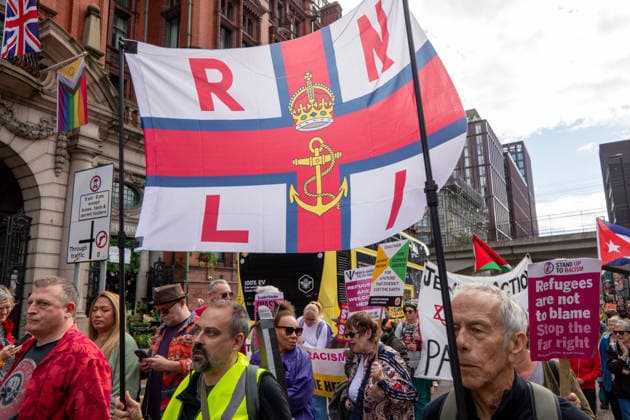September 26, 2026, Manchester, United Kingdom: Protesters hold a banner with RNLI (Royal National Lifeboat Institution) during the rally. Activists in Manchester march for Stand Up To Racism against the far right. In addition to anti-racist slogans promoting diversity and migrant rights, demonstrators carried banners of the RNLI (Royal National Lifeboat Institution) following recent Patriot Platform protests. The broad coalition of trade unions, community groups, and political organisations featured prominent banners from BECTU (Broadcasting, Entertainment, Communications and Theatre Union) and Jewish Voice for Labour (JVL). Manchester, United Kingdom. Manchester United Kingdom - ZUMAs197 20260926_aaa_s197_212 Copyright: xGaryxRobertsx