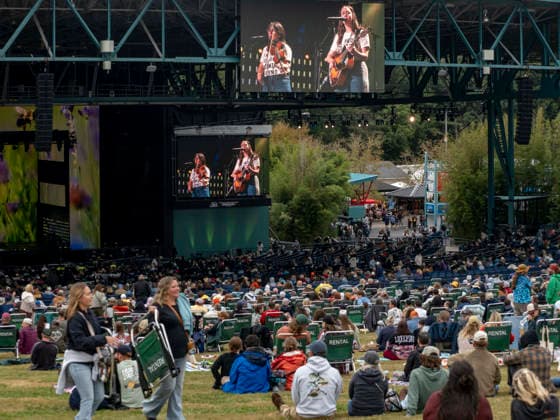 September 26, 2026, Virginia Beach, Virginia, USA: SARA WILKINS and SARAH JAROSZ of the band IM WITH HER are shown on jumbo screens as they play at Farm Aid 2026. Through music and family farm produced food, and farmer presentations, this annual festival shines a spotlight on the critical need for family farms to succeed. Virginia Beach USA  - ZUMAd155 20260926_znp_d155_013 Copyright: xSuexDorfmanx
