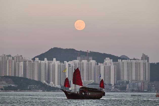 HONG KONG, CHINA - SEPTEMBER 26: A full moon rises over Victoria Harbour as a boat sails on the sea during the Mid-Autumn Festival holiday on September 26, 2026 in Hong Kong, China.  Copyright: xChinaxNewsxServicex 111669755587