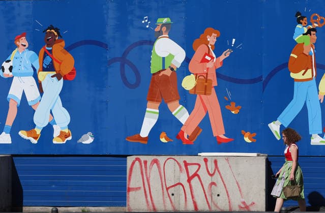 Germany world s largest beer festival Oktoberfest A girl in traditional Bavarian clothing walks past a mural depicting figures during the world s largest beer festival Oktoberfest in Munich, Germany, September 27th , 2026 . Photo by Davide Elias Copyright: xDavidexEliasx