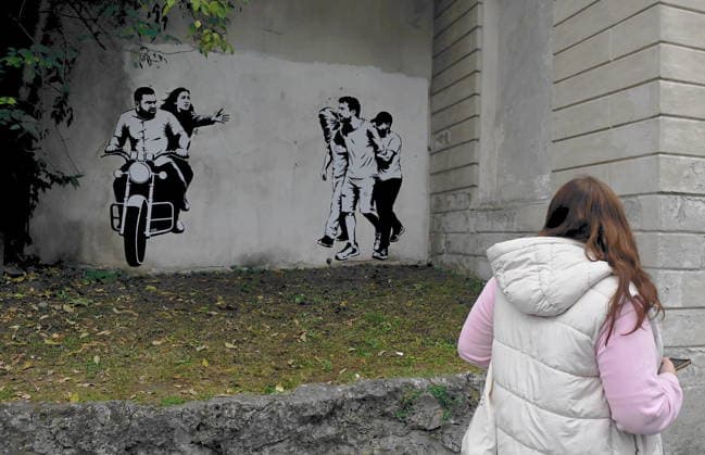 IPA89393689 - MILAN - October 7, 2026 - A mural by Alexandro Palombo, an artwork on display on October 7 at the Museum of Modern Art, located at 16 Via Palestro, dedicated to the young couple kidnapped during the attack on the Nova Music Festival  Copyright: xMaurizioxMaulex xMaurizioxMaulex IPA89393689