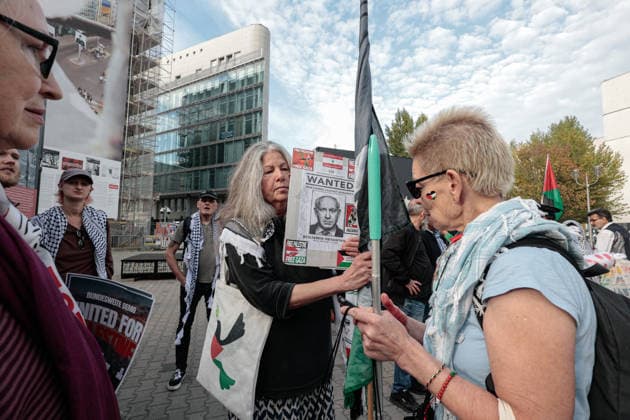 Third anniversary of the Hamas-led October 7, 2023 attack on Israel in Berlin, Germany -7 OCT 2026. A female pro-Palestinian protester seen holding a placard reading Netanyahu Wanted at Checkpoint Charlie during a demonstration marking the third anniversary of the Hamas-led October 7, 2023 attack on Israel. Berlin’s assembly authority listed a separate demonstration from 4 p.m. to 6 p.m. at Zimmerstrasse 77, near Checkpoint Charlie. Its registered slogan called for an end to the war in Gaza, an end to arms deliveries to Israel and the prosecution of alleged war crimes. Checkpoint Charlie, a former border crossing between East and West Berlin during the Cold War, is one of the city’s best-known landmarks. The site has also become a regul Copyright: xVasilyxKrestyaninovx xSOPAxImagesx _VKR4548