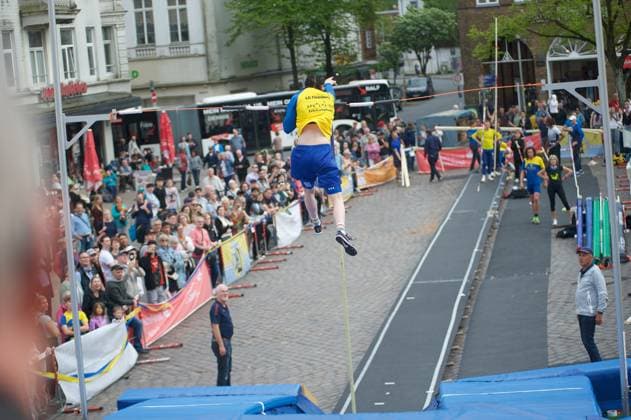 Flensburg, Schleswig-Holstein 1. Flensburger Marktplatzspringen, im Rahmen des Active City Festivals. Hier: Stabhochspringer beim Spung, er überwindet die Latte. Aufnahme vom 04.05.2024, Flensburg, Südermarkt