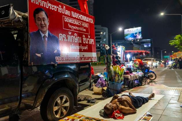 May 10, 2026, Bangkok, Bangkok, Thailand: A supporter of jailed former Prime Minister Thaksin Shinawatra sleeps outside Klong Prem Central Prison in Bangkok, Thailand, on May 10, 2026, the night before his expected parole release after serving two-thirds of a one-year sentence. Thaksin was convicted on corruption charges in 2023 and sentenced to eight years in prison, later reduced to one year by royal pardon. His case drew renewed controversy after his initial sentence was served almost entirely in a luxury ward at Thailandâ€⠢s Police General Hospital, leading to his subsequent return to prison. Bangkok Thailand - ZUMAt128 20260510_zap_t128_007 Copyright: xAdryelxTalamantesx