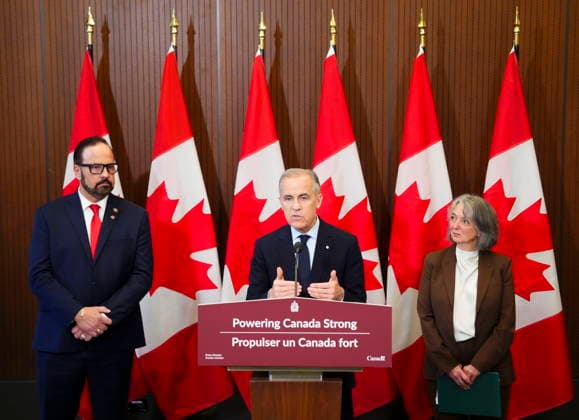 May 14, 2026, Ottawa, On, Canada: Prime Minister Mark Carney makes an announcement alongside Russ Shewchuk International Vice -President for International Brotherhood of Electrical Workers (IBEW) First District, left, and Minister of Environment and Climate Change Julie Dabrusin, right, on Parliament Hill in Ottawa on Thursday, May 14, 2026. Ottawa Canada - ZUMAc35_ 20260514_zaf_c35_008 Copyright: xSeanxKilpatrickx