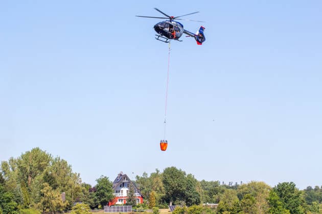 Plauen - Polizeihubschrauber unterstützen Löscharbeiten bei Waldbrand in Plauen Plauen, Meßbach, Messbach, Vogtland, Sachsen, Waldbrand, Vegetationsbrand, Feuerwehr, Löscharbeiten, Polizeihubschrauber, Polizei Sachsen, sächsische Polizei, H145, Airbus H145, Löschhubschrauber, Hubschrauber, Luftunterstützung, Bambi Bucket, Löschwasserbehälter, Außenlast, Wasseraufnahme, Wasserabwurf, Talsperre Pirk, Pirk, Katastrophenschutz, Einsatz, Brandbekämpfung, Glutnester, wildfire, forest fire, firefighting helicopter, aerial firefighting Plauen Sachsen Deutschland Copyright: xEHLxMediax 20260812_plauen-waldbrand-hubschrauber_5