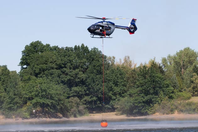 Plauen - Polizeihubschrauber unterstützen Löscharbeiten bei Waldbrand in Plauen Plauen, Meßbach, Messbach, Vogtland, Sachsen, Waldbrand, Vegetationsbrand, Feuerwehr, Löscharbeiten, Polizeihubschrauber, Polizei Sachsen, sächsische Polizei, H145, Airbus H145, Löschhubschrauber, Hubschrauber, Luftunterstützung, Bambi Bucket, Löschwasserbehälter, Außenlast, Wasseraufnahme, Wasserabwurf, Talsperre Pirk, Pirk, Katastrophenschutz, Einsatz, Brandbekämpfung, Glutnester, wildfire, forest fire, firefighting helicopter, aerial firefighting Plauen Sachsen Deutschland Copyright: xEHLxMediax 20260812_plauen-waldbrand-hubschrauber_8