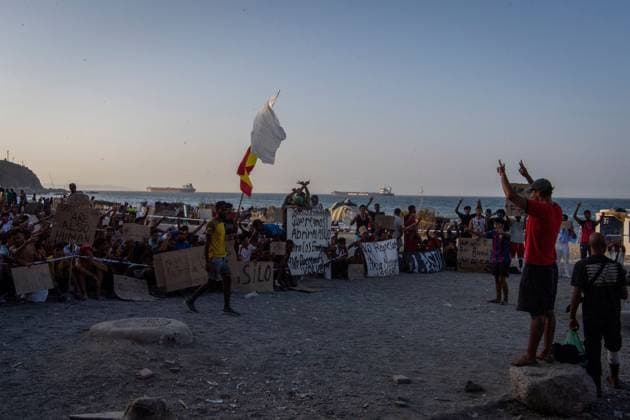 August 17, 2026, Ceuta, Spain: CEUTA, SPAIN †AUGUST 17, 2026: More than 100 migrants, most of them Moroccan, have been protesting for days in front of National Police vans during the daily food distribution provided by the Spanish Red Cross at TrampoloÂn Beach. â€oeNo asylum, no food†is the chant repeated by the migrants on the sand, while African migrants continue to stay in the temporary accommodation facilities set up on the Ceuta beach. Authorities are expected to clear the beach in the coming days and transfer the migrants to four reception facilities announced today by Spainâ€⠢s Minister for Migration, Elma Saiz. Ceuta Spain - ZUMAq101 20260817_zna_q101_082 Copyright: xAntonioxSemperex