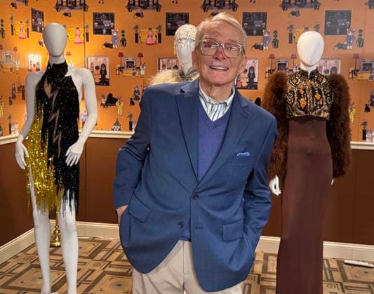 December 2, 2024, New York, New York, USA: American fashion designer and costumier BOB MACKIE seen with his creations, (L-R) Bob Mackie 1987 Archival Earthquake dress worn by Pink during the 2022 AMA Awards, estimate $5000 - $6000, and two-piece evening ensemble designed by Bob Mackie for Cher worn numerous times for publicity images, and The Sonny and Cher Show, where Cher covered Ethel Waters 1933 song ‘Stormy Weather,â€⠢ August 22, 1971 estimate $3,000 and $5,000, seen during the press preview for the Hollywood Legends ‘Unmistakably Mackieâ€⠢ auction presented by Julienâ€⠢s Auctions and Turner Classic Movies held at the Carlyle Hotel. New York USA - ZUMAk03_ 20241202_zaf_k03_077 Copyright: xNancyxKaszermanx