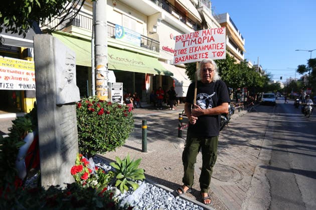 September 18, 2026, Keratsini, Attica, GREECE: Giannis Maggos, father of Vasileios Maggos, stands beside the memorial of Pavlos Fyssas holding a placard calling for justice for his son during a gathering marking the 13th anniversary of Fyssas murder in Keratsini, near Athens, Greece, September 18, 2026. Keratsini GREECE - ZUMAx103 20260918_zip_x103_003 Copyright: xHarrisxXanthopoulosx
