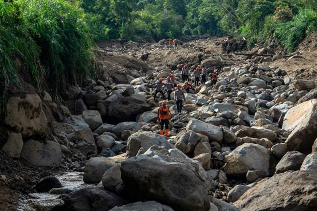 September 23, 2026, Solok Regency, Indonesia: SOLOK, WEST SUMATRA, INDONESIA, SEPTEMBER 23, 2026: Members of a joint search and rescue team comb an area affected by flash flooding in Arosuka, Solok, West Sumatra, as operations continue to locate a missing resident. Search teams from Indonesiaâ€⠢s National Search and Rescue Agency (BASARNAS), working alongside local residents, are searching for 59-year-old Agusral, who was reported missing after being swept away by floodwaters on September 21. Search efforts focused on several locations along the path of flood debris and a nearby river. Solok Regency Indonesia - ZUMAq101 20260923_zna_q101_026 Copyright: xWawanxKurniawanx