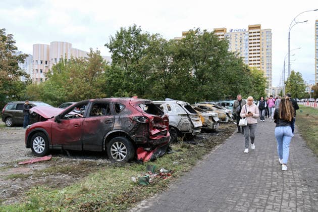 People walk past burnt-out cars at a parking lot in the Podilskyi district after an overnight Russian attack, Kyiv, Ukraine, September 24, 2026. On Thursday night, September 24, Russian forces launched a ballistic missile strike on Kyiv, followed by drone assaults on the capital and region. By morning, two people were confirmed killed and eight injured. The attack caused fires and destruction across several districts, damaging medical facilities, apartment blocks, private homes, and vehicles. The maternity hospital in the Podilskyi district sustained damage to windows, doors, and parts of the facade from the first to fifth floors, as well as to windows in the laundry and boiler rooms. Patients, children, and medical staff were unharmed, hav Copyright: xPavloxBahmutx