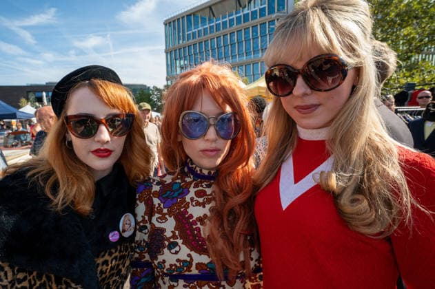 September 26, 2026, London, United Kingdom: Three women dressed in vintage clothing attend the September King™s Cross Classic Car Boot Sale at Granary Square in King™s Cross, London. The Kings Cross Classic Car Boot Sale returned to Granary Square and Stable Street, King™s Cross, London, for its 11th year. Held several times throughout the year, the event brings together vintage fashion, second-hand clothing, jewellery, homewares, collectables and vinyl records alongside classic cars, motorcycles and commercial vehicles. Visitors browsed stalls and traders, with many making a special effort to dress in period clothing inspired by the 1950s, 1960s and 1970s.continuing a tradition associated with the event. London United Kingdom - ZUMAs197 20260926_aaa_s197_392 Copyright: xJamesxWilloughbyx