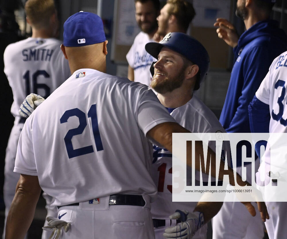 Los Angeles Dodgers Max Muncy (13) celebrates with teammate Albert Pujols in the dugout after hitting a solo home run off Arizona Diamondbacks starting pitcher Merrill Kelly in the fifth inning to give the Dodgers a 4-2 lead at Dodger Stadium in Los Angeles on Wednesday, September 15, 2021. Puljos, a former recipient of the Roberto Clemente philanthropic and humanitarian award is wearing number 21 in honor of Roberto Clemente Day. LAP2021091502 JIMxRUYMEN