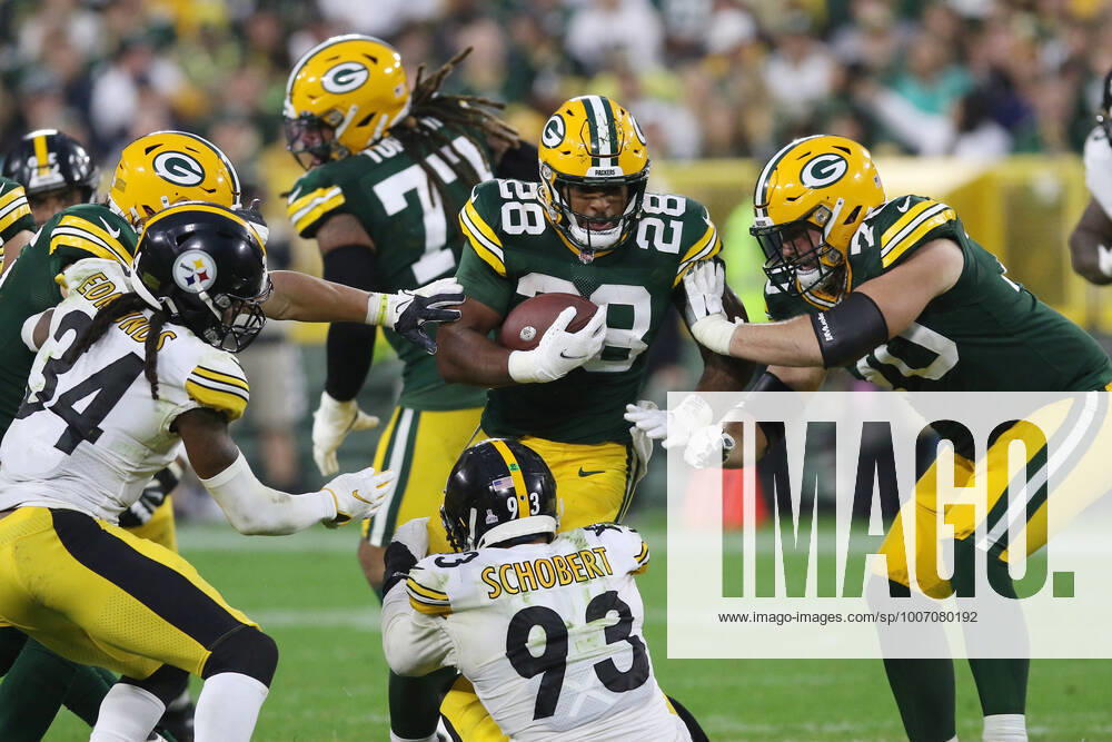 GREEN BAY, WI - OCTOBER 03: Green Bay Packers running back A.J. Dillon (28) runs through Pittsburgh Steelers inside linebacker Joe Schobert (93) during a game between the Green Bay Packers and the Pittsburgh Steelers at Lambeau Field on October 3, 2021 in Green Bay, WI. (Photo by Larry Radloff Icon Sportswire) NFL, American Football Herren, USA OCT 03 Steelers at Packers Icon2110034402