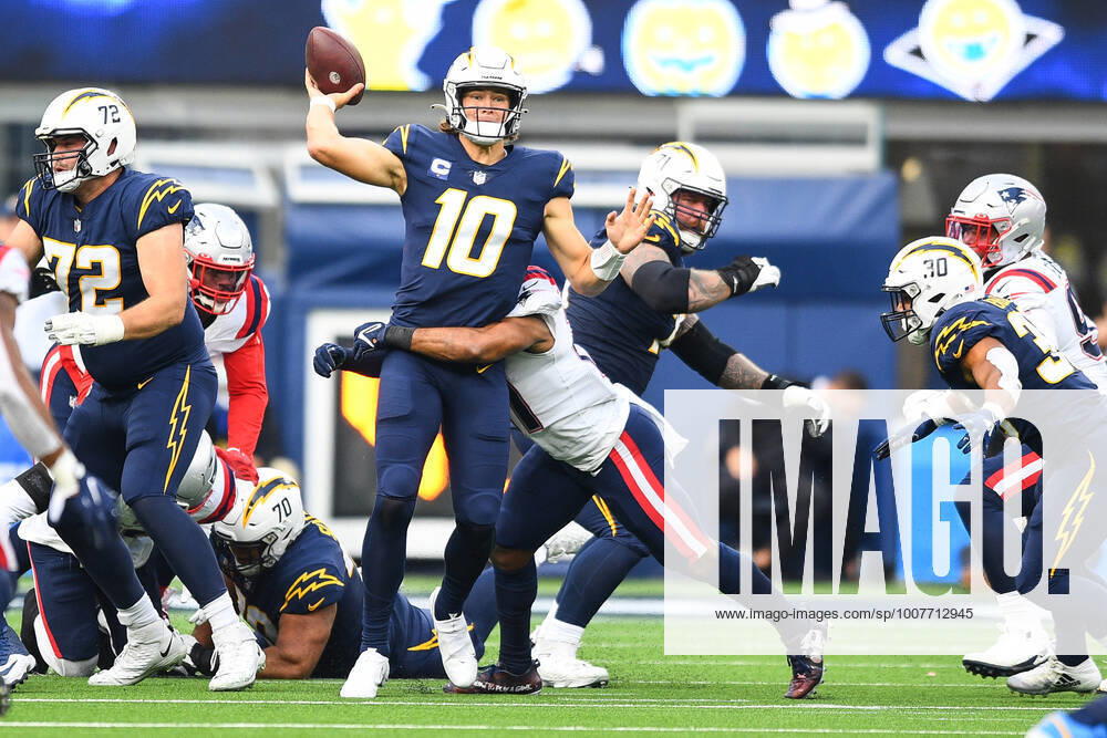 INGLEWOOD, CA - OCTOBER 31: Los Angeles Chargers Quarterback Justin Herbert (10) throws a pass as he is hit during the NFL, American Football Herren, USA game between the New England Patriots and the Los Angeles Chargers on October 31, 2021, at SoFi Stadium in Inglewood, CA. (Photo by Brian Rothmuller Icon Sportswire) NFL: OCT 31 Patriots at Chargers Icon211031019