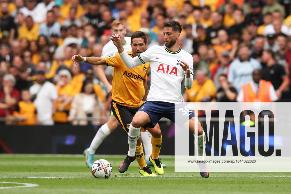 Rodrigo Bentancur of Tottenham Hotspur is challenged by Joao Moutinho of Wolverhampton Wanderers during the Premier League match between Tottenham Hotspur and Wolverhampton Wanderers at Tottenham Hotspur Stadium, London, England on 20 August 2022.