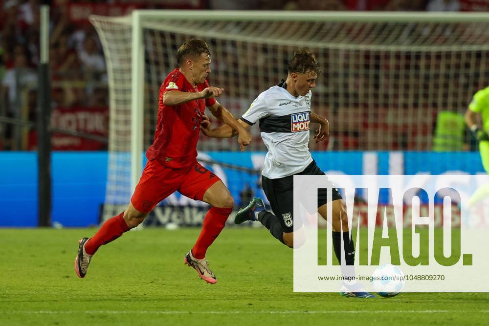 Im Zweikampf, Aktion, mit Joshua Kimmich 6 (FC Bayern Muenchen), Maurice Krattenmacher 30 (SSV Ulm 1846), SSV Ulm 1846 vs. FC Bayern Muenchen, Fussball, DFB-Pokal, 1. Runde, 16.08.2024 DFB regulations prohibit any use of photographs as image sequences and or quasi-video Ulm Baden-Wuerttemberg Deutschland