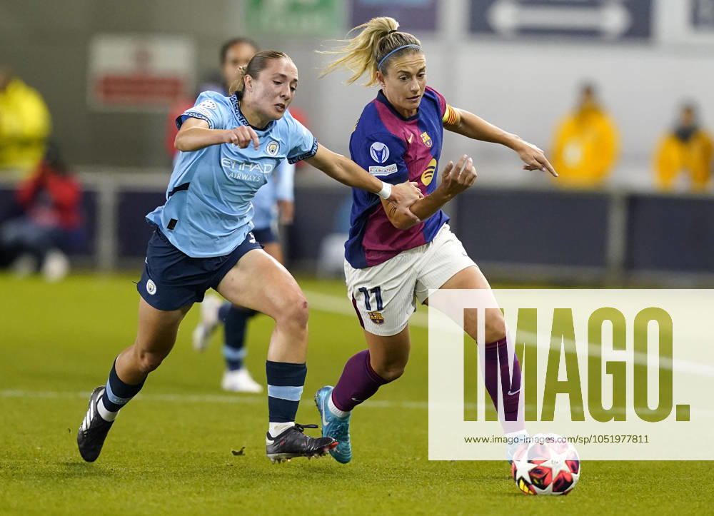 Manchester, England, 9th October 2024. Alexia Putellas of Barcelona (R) is challenged by Naomi Layzell of Manchester City during the UEFA Womens Champions League match at the Academy Stadium, Manchester. Picture credit should read: Andrew Yates Sportimage . SPI-3368-0006