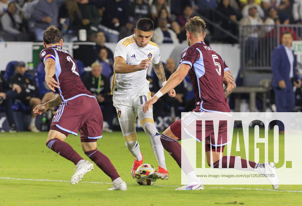 Gabriel Pec 11 of the LA Galaxy is defended by Keegan Rosenberry 2 and Andreas Maxso 5 of the Colorado Rapids during the Audi 2024 MLS, Fussball Herren, USA Cup Playoffs Round One Game 1 of 3 on Saturday October 26, 2024 at Dignity Health Sports Park Stadium in Carson, California. The Galaxy defeats Rapids, 5-0. JAVIER ROJAS PI Los Angeles USA - ZUMAp124 20241026_zaa_p124_055