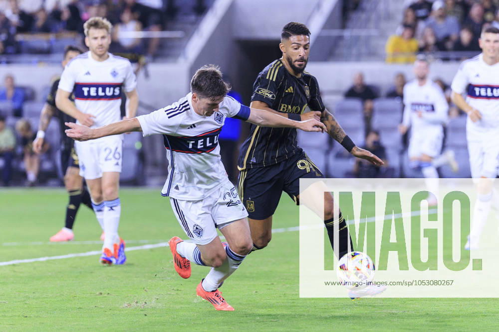 Denis Bouanga 99 of the Los Angeles Football Club and Ryan Gauld 25 of the Vancouver Whitecaps struggle for possession of the ball during the Audi 2024 MLS, Fussball Herren, USA Cup Playoffs Round One Game 1 of 3 on Sunday October 27, 2024 at BMO Stadium in Los Angeles, California. LAFC defeats Whitecaps, 2-1. ARIANA RUIZ PI Los Angeles U.S - ZUMAp124 20241027_zaa_p124_047