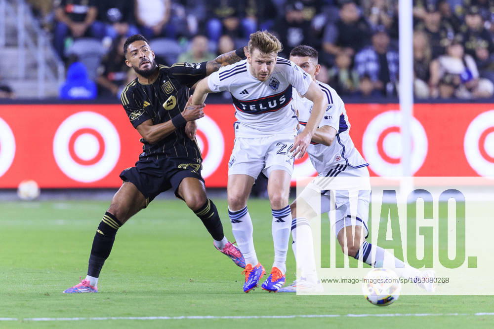 Denis Bouanga 99 of the Los Angeles Football Club attempts to steal the ball from Stuart Armstrong 26 of the Vancouver Whitecaps during the Audi 2024 MLS, Fussball Herren, USA Cup Playoffs Round One Game 1 of 3 on Sunday October 27, 2024 at BMO Stadium in Los Angeles, California. LAFC defeats Whitecaps, 2-1. ARIANA RUIZ PI Los Angeles U.S - ZUMAp124 20241027_zaa_p124_048