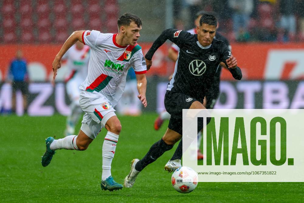 Im Zweikampf, Aktion, mit Robin Fellhauer 19 (FC Augsburg), Adam Daghim 11 (VfL Wolfsburg), FC Augsburg vs. VfL Wolfsburg, Fussball, 1. Bundesliga, 6. Spieltag, 04.10.2025 DFB regulations prohibit any use of photographs as image sequences and or quasi-video Augsburg Bayern Deutschland
