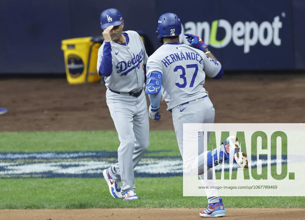 Los Angeles Dodgers Teoscar Hernandez (37) is congratulated by third base coach Dino Ebel after hitting a solo home run in the second inning against the Milwaukee Brewers during game two of the MLB, Baseball Herren, USA National League Championship Series at American Family Field in Milwaukee, Wisconsin, on Tuesday, October 14, 2025. MIL20251014708 TANNENxMAURY