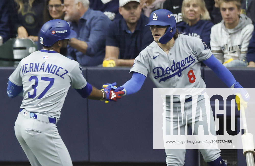 Los Angeles Dodgers Teoscar Hernandez (37) is congratulated by Enrique Hernandez (8) after hitting a solo home run in the second inning against the Milwaukee Brewers during game two of the MLB, Baseball Herren, USA National League Championship Series at American Family Field in Milwaukee, Wisconsin, on Tuesday, October 14, 2025. MIL20251014709 TANNENxMAURY