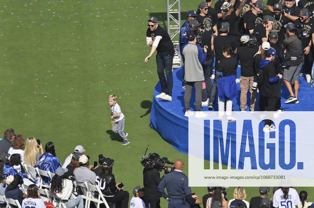 Los Angeles Dodgers first baseman Freddie Freeman (L) keeps an eye on his son Maximus as he celebrates their World Series win with teammates and fans following a parade at Dodger Stadium in Los Angeles on Monday, November 3, 2025. LAP2025110315 JIMxRUYMEN