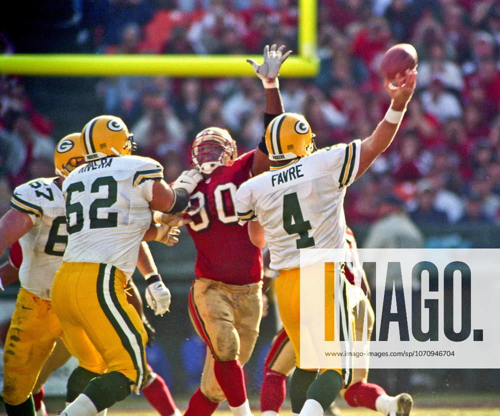San Francisco, California, U.S - San Francisco 49ers vs. Green Bay Packers Candlestick Park Sunday, January 3, 1999. 49ers beat Packers 30-27. San Francisco 49ers defensive tackle Junior Bryant (90) rushes Green Bay Packers quarterback Brett Favre