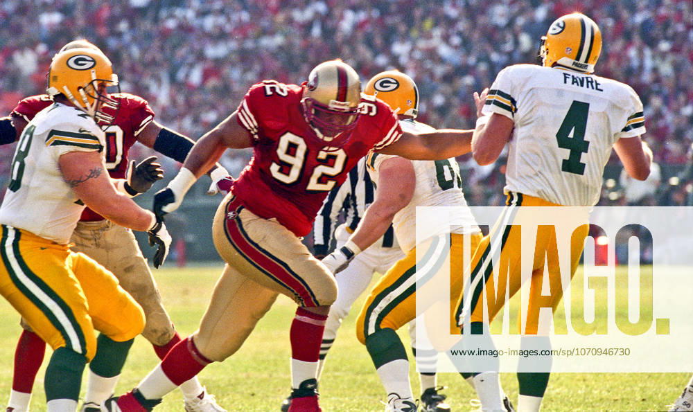 San Francisco, California, U.S - San Francisco 49ers vs. Green Bay Packers Candlestick Park Sunday, January 3, 1999. 49ers beat Packers 30-27. San Francisco 49ers defensive end Roy Barker (92) rushes Green Bay Packers quarterback Brett Favre