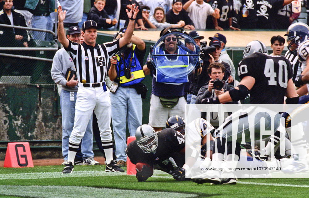 Oakland, California, U.S - Oakland Raiders vs. San Diego Chargers at Oakland Alameda County Coliseum Sunday, November 14, 1999. Raiders beat Chargers 28-9. Oakland Raiders running back Tyrone Wheatley (47) dives for touchdown.