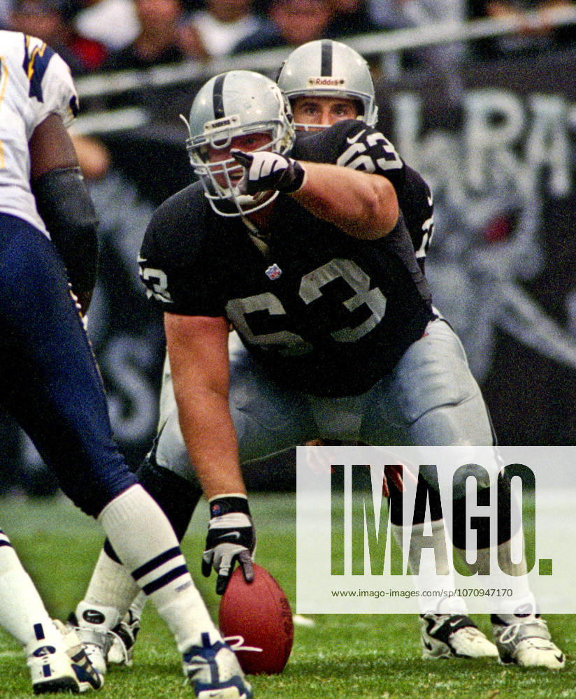 Oakland, California, U.S - Oakland Raiders vs. San Diego Chargers at Oakland Alameda County Coliseum Sunday, November 14, 1999. Raiders beat Chargers 28-9. Oakland Raiders center Barret Robbins (63) and quarterback Rich Gannon