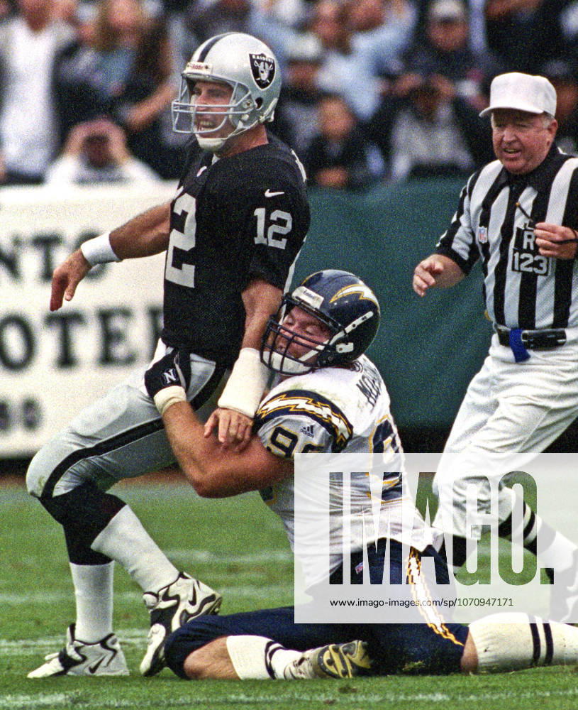 Oakland, California, U.S - Oakland Raiders vs. San Diego Chargers at Oakland Alameda County Coliseum Sunday, November 14, 1999. Raiders beat Chargers 28-9. San Diego Chargers defensive tackle Mike Mohring (98) and Oakland Raiders quarterback Rich Gannon