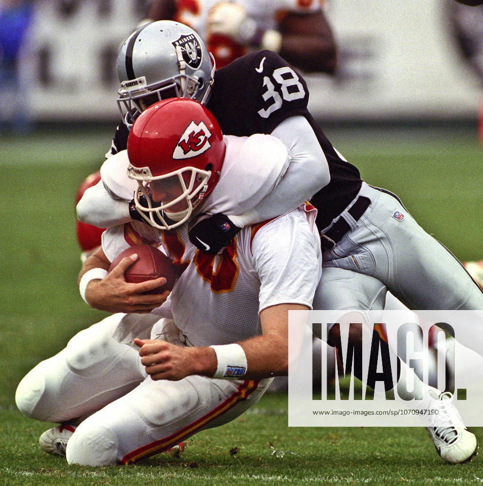 Oakland, California, U.S - Oakland Raiders vs. Kansas City Chiefs at Oakland Alameda County Coliseum Sunday, November 29, 1999. Chiefs beat Raiders 37-34. Oakland Raiders defensive back Marquis Walker (38) sacks Kansas City Chiefs quarterback Elvis Grbac