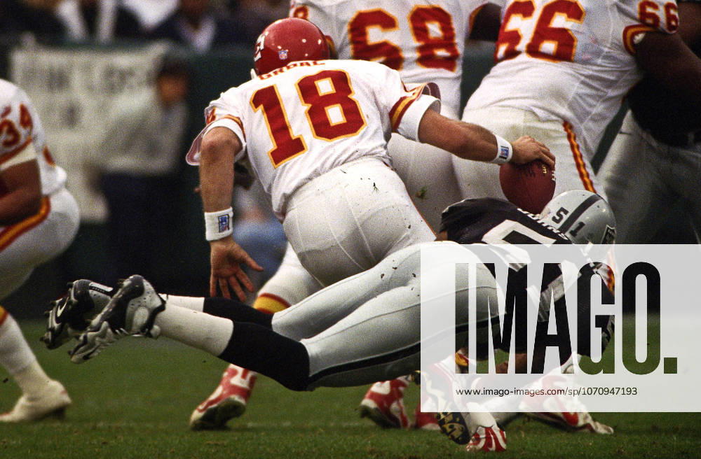 Oakland, California, U.S - Oakland Raiders vs. Kansas City Chiefs at Oakland Alameda County Coliseum Sunday, November 29, 1999. Chiefs beat Raiders 37-34. Oakland Raiders defensive end Lance Johnstone (51) sacks Kansas City Chiefs quarterback Elvis Grbac