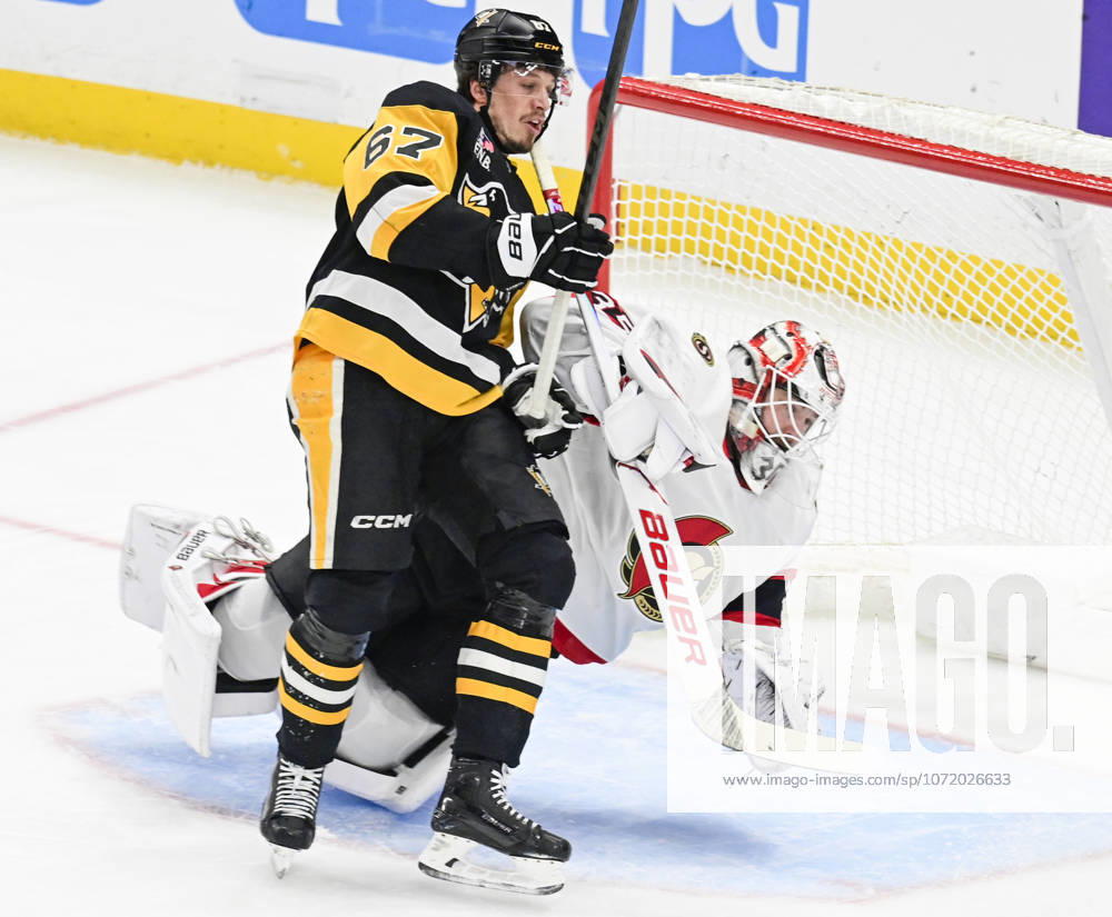 Pittsburgh Penguins right wing Rickard Rakell (67) receives a goalie Interference penalty as he collides with Ottawa Senators goaltender Linus Ullmark (35) during the first period at PPG Paints Arena in Pittsburgh on Monday, February 2, 2026. PIT2026020204 ARCHIExCARPENTER