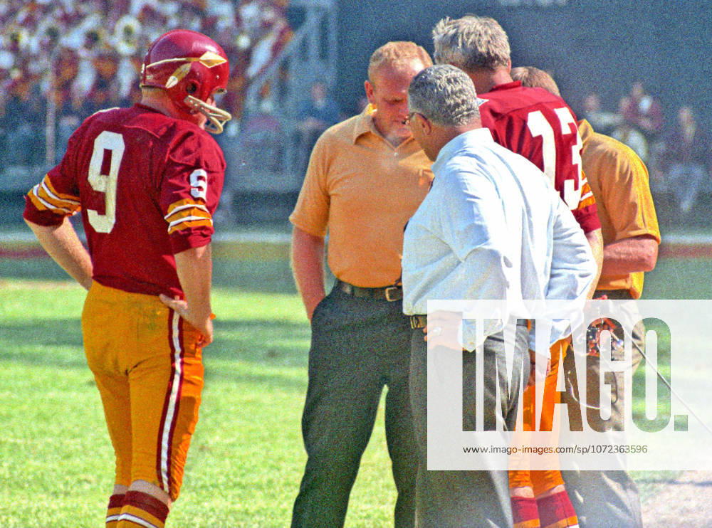 Washington Redskins quarterback Sonny Jurgensen 9, left, speaks to coaches Bill Austin and Vince Lombardi, and back-up quarterback Frank Ryan 13 on the sidelines during a break in the action against the New York Giants at RFK Stadium in Washington, D.C. on October 19, 1969. The Redskins won the game 20 - 14 Washington USA - ZUMAs152 19691019_faa_s152_002
