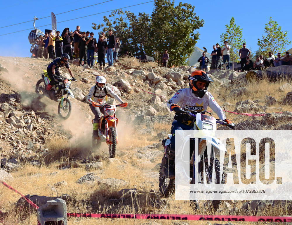Motocross riders navigate a steep and rocky downhill path during the enduro championship Competitors test their skills on the rugged terrain maneuvering their bikes over loose stones and natural obstacles Riders Battle Rugged Terrain High On Mount Korek - ZUMAy105 20251017_zip_y105_022