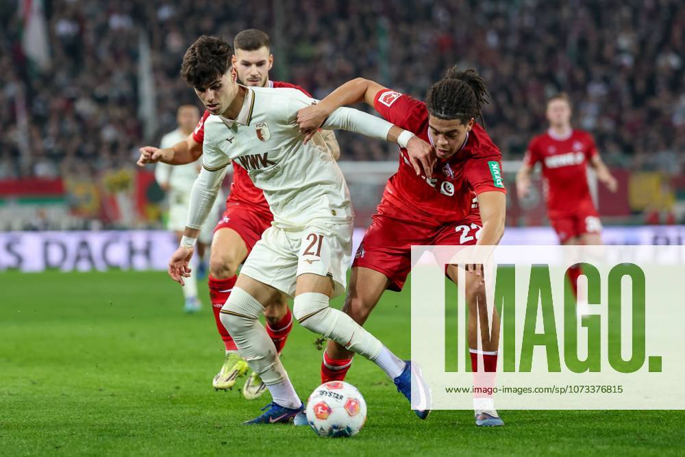 Im Zweikampf, Aktion, mit Rodrigo Ribeiro 21 (FC Augsburg), Jahmai Simpson-Pusey 22 (1. FC Koeln), FC Augsburg vs. 1. FC Koeln, Fussball, 1. Bundesliga, 24. Spieltag, 27.02.2026 DFB regulations prohibit any use of photographs as image sequences and or quasi-video Augsburg Bayern Deutschland