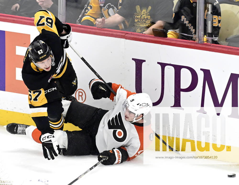 Pittsburgh Penguins right wing Rickard Rakell (67) and Philadelphia Flyers defenseman Jamie Drysdale (9) collide against the boards behind the goal during the overtime period of the 4-3 shootout win at PPG Paints Arena in Pittsburgh on Saturday, March 7, 2026. PIT2026030719 ARCHIExCARPENTER