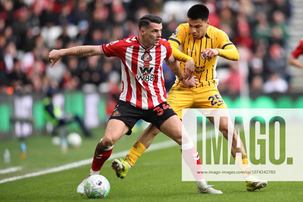 Sunderland v Brighton & Hove Albion - Premier League Granit Xhaka of Sunderland is challenged by Diego Gomez of Brighton and Hove Albion during the Premier League match between Sunderland and Brighton and Hove Albion at the Stadium of Light in Sunderland, United Kingdom, on March 14, 2026. Sunderland Tyne and Wear United Kingdom