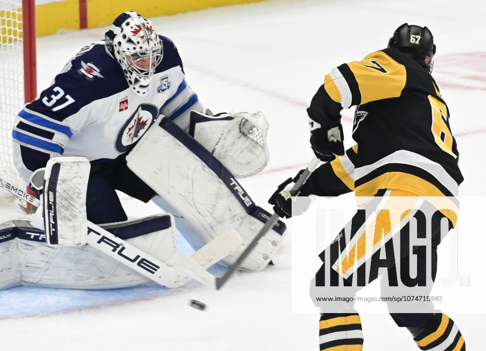 Pittsburgh Penguins right wing Rickard Rakell (67) scores on Winnipeg Jets goaltender Connor Hellebuyck (37) during the overtime penalty shot shootout in the Pittsburgh Penguins 5-4 win at PPG Paints Arena in Pittsburgh on Saturday, March 21, 2026. PIT2026032113 ARCHIExCARPENTER
