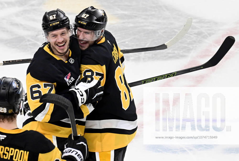 Pittsburgh Penguins right wing Rickard Rakell (67) celebrates his the overtime penalty shot goal with Pittsburgh Penguins center Sidney Crosby (87) following the Penguins 5-4 win against the Winnipeg Jets at PPG Paints Arena in Pittsburgh on Saturday, March 21, 2026. PIT2026032115 ARCHIExCARPENTER
